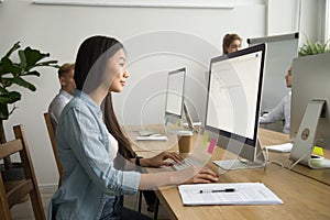 Young asian businesswoman using computer working online in cowor