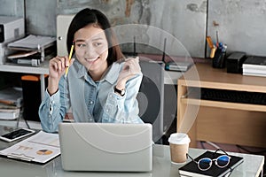 Young asian businesswoman working with laptop computer at office