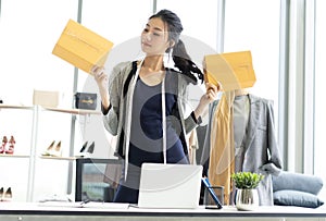 Young Asian casual business woman working small business online working with box at her office, SME  and Delivery Concept ,Online