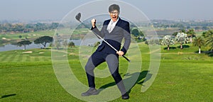 Young Asian CEO Businessman wearing suite playing golf at the golf course. Portrait of Asian businessman joying to success