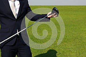 Young Asian CEO Businessman wearing suits and playing golf at the golf course. Portrait of Asian businessman. Close up hand with