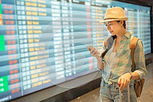 Young Asian checking flight timetable