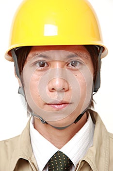 Young Asian construction worker with a serious expression