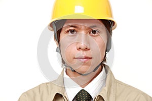 Young Asian construction worker with a serious expression
