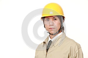 Young Asian construction worker with a serious expression