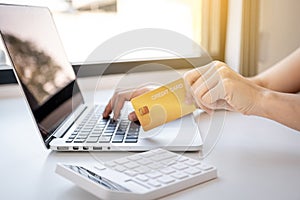 Young Asian consumer woman hand holding a credit card, Ready to spending pay online shopping according to discount products via