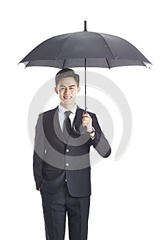 Young asian corporate executive holding a black umbrella