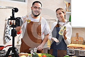 Asian couple blogger vlogger and online influencer recording video content on healthy food in the kitchen