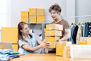 Young Asian couple business working in simple house office look like doing startup business and check store order by laptop,