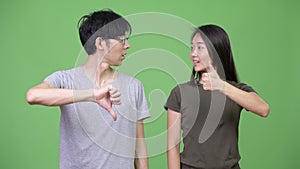 Young Asian couple having different decisions together