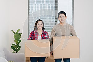 Young asian couple moving to a new apartment together relocation