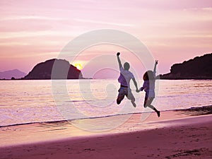 Young asian couple rejoicing at sunrise photo