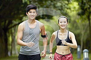 Young asian couple running jogging in a park