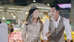 Young Asian couple shopping in supermarket