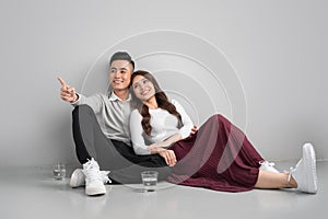 Young asian couple sitting together on floors at home