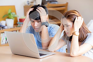 Young asian couple stressed and worried about finance of problem business together