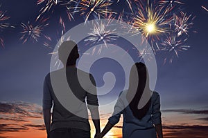 Young asian couple watching spectacular fireworks