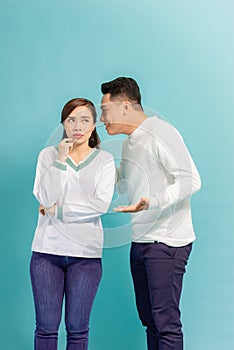 Young Asian couple whisper, closeup portrait