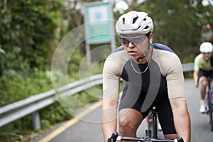 young asian cycling athlete training outdoors