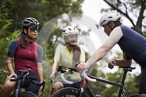 young asian cyclists chatting outdoors photo