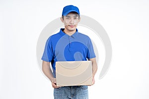 Young Asian delivery man in blue uniform standing with parcel post box isolated over white background.Delivery Service and Onlines
