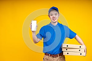 Young Asian delivery man holding food or pizza box and showing application on mobile