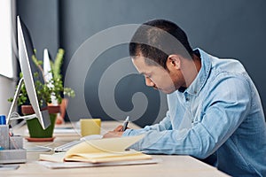 Young Asian designer hard at work in an office
