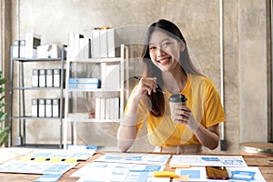 Young asian designer woman drawing a website outline and website ux app development on mobile phone.