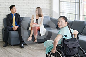 Young Asian disabled businesswoman sitting in wheelchair  working her job and use smartphone talking with her customer, the
