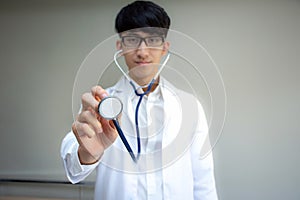 Young Asian doctor with a stethoscope in the hands