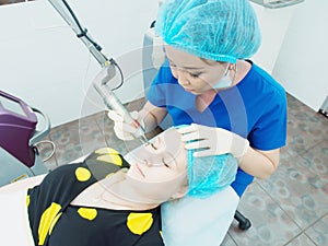 Young asian doctor woman making to patient laser skin resurfacing in aesthetic medicine