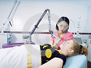 Young asian doctor woman making to patient laser skin resurfacing in aesthetic medicine