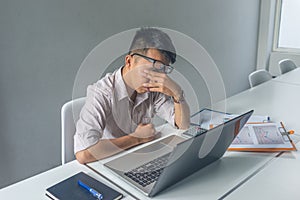 Young Asian employee feel tired and frustrated with job