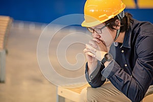 Asian engineer man feeling tried and stressed