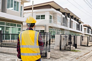 Young Asian engineer inspects architecture, construction project concept, young professional engineer in helmet