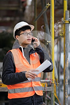 Young Asian engineer working on construction site