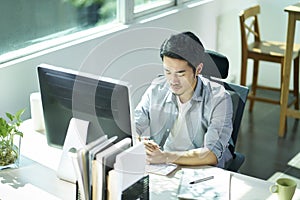 Young asian entrepreneur contemplating in office