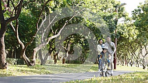 Young asian family enjoying outdoor activity in park