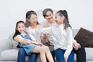 Young asian family entertained at home in free time photo