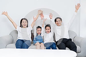 Young asian family entertained at home in free time photo