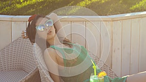 Young asian fashion woman drinking cocktail in a beach bar.