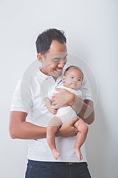 Young Asian father holding his adorable baby