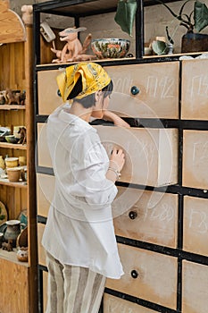 Young asian female ceramicist in headscarf photo