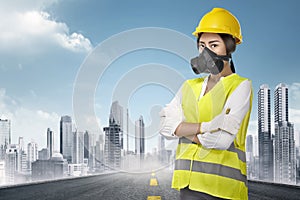 Young asian female construction worker with yellow helmet and un