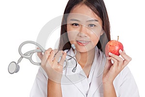 Young Asian female doctor hold apple and stethoscope