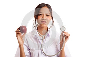 Young Asian female doctor hold apple and stethoscope
