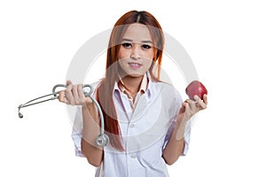 Young Asian female doctor hold apple and stethoscope.