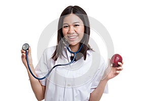 Young Asian female doctor hold apple and stethoscope.