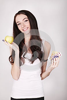 Young Asian female doctor with pills and apple