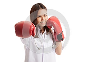 Young Asian female doctor punch with boxing glove.